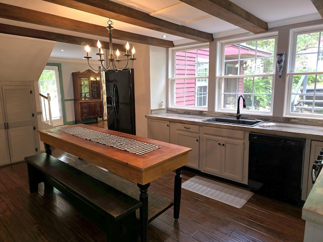 kitchen featuring dark hardwood / wood-style flooring, sink, black appliances, a chandelier, and hanging light fixtures