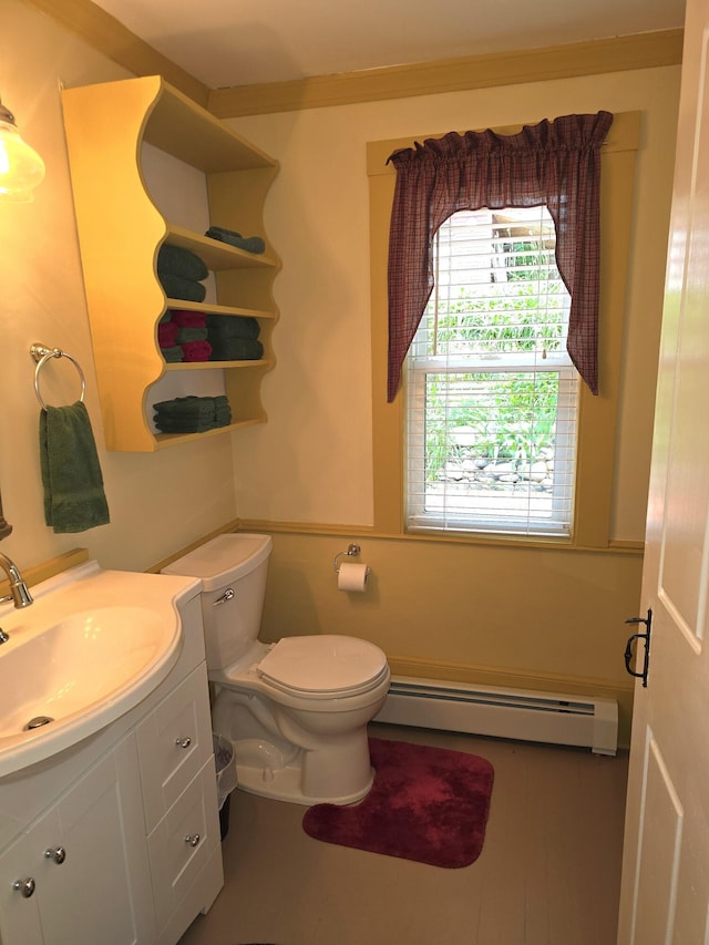 bathroom featuring vanity, toilet, and a baseboard heating unit