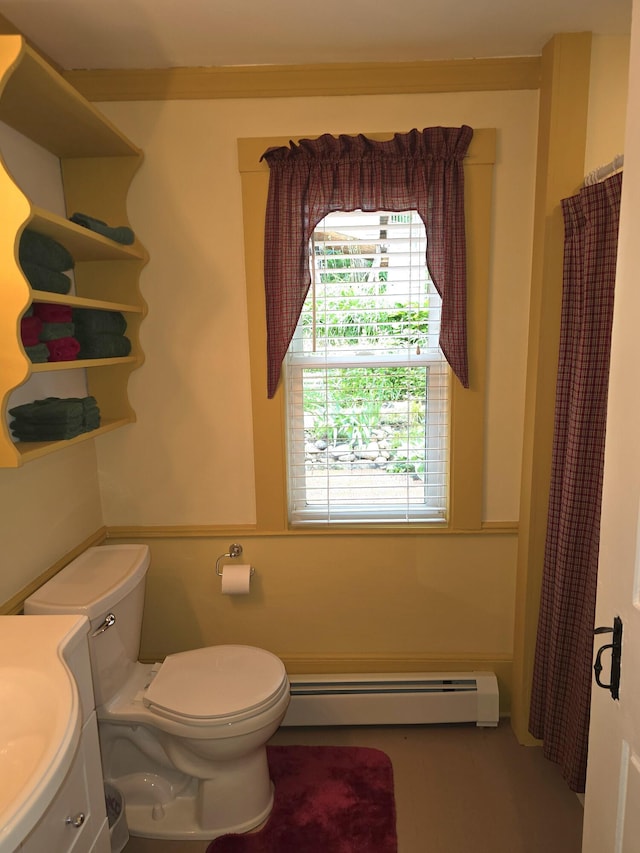 bathroom with vanity, toilet, and a baseboard heating unit