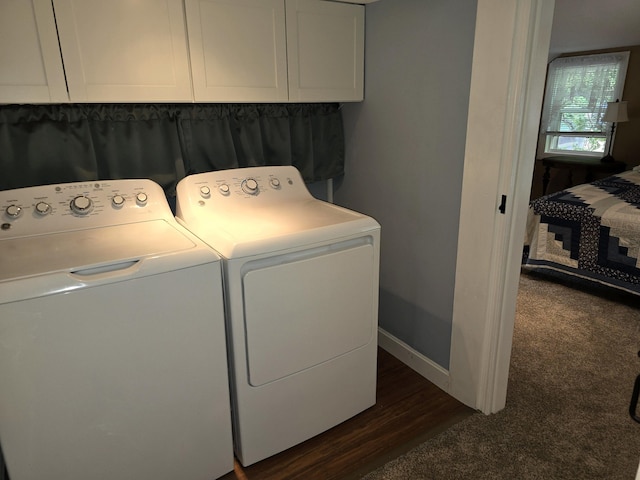 washroom featuring cabinets, dark hardwood / wood-style flooring, and separate washer and dryer