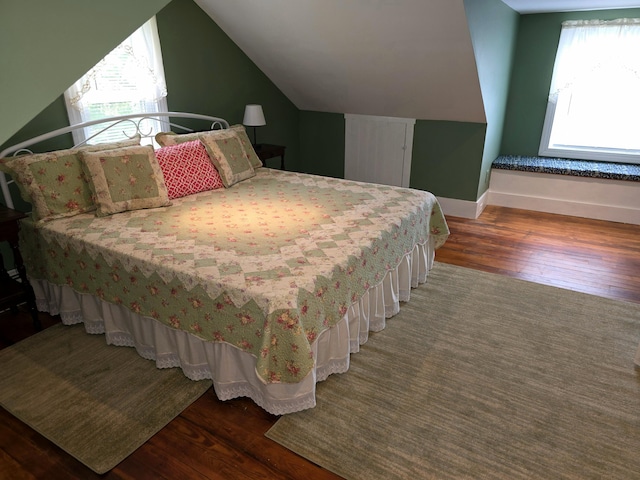 bedroom featuring dark hardwood / wood-style floors and vaulted ceiling