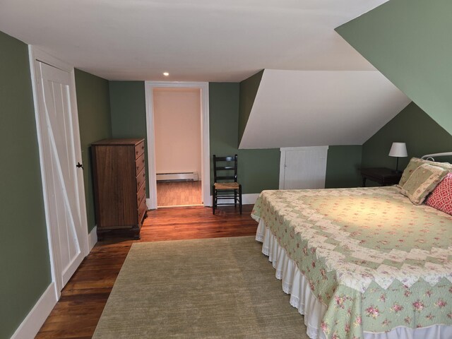 bedroom featuring baseboard heating and dark wood-type flooring