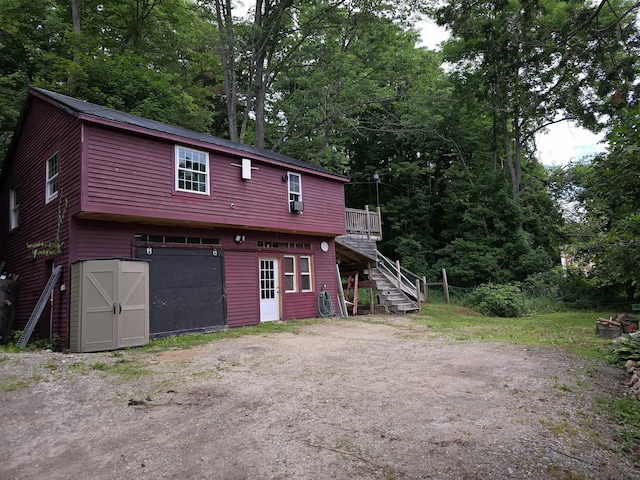 back of property featuring an outbuilding and a wooden deck