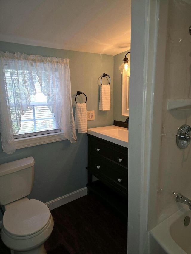 full bathroom featuring hardwood / wood-style floors, vanity, toilet, and shower / bath combination