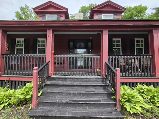 doorway to property featuring covered porch