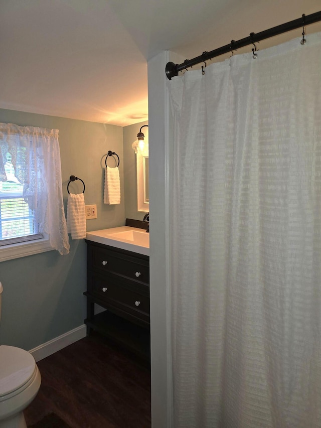 bathroom featuring hardwood / wood-style floors, vanity, and toilet