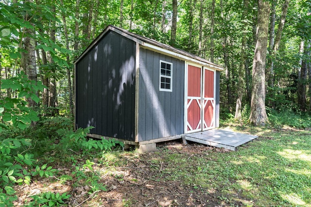 view of shed with a wooded view