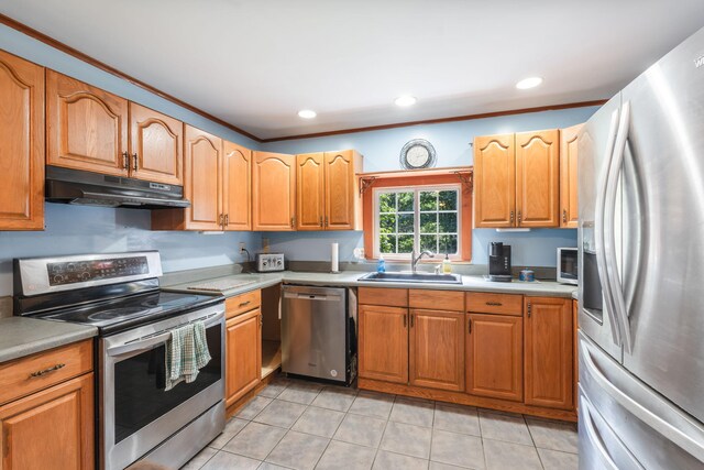 kitchen with a sink, appliances with stainless steel finishes, under cabinet range hood, and recessed lighting