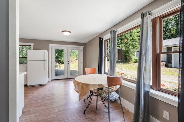dining space featuring baseboards and light wood-type flooring