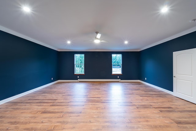 spare room featuring ceiling fan, light hardwood / wood-style floors, ornamental molding, and baseboard heating