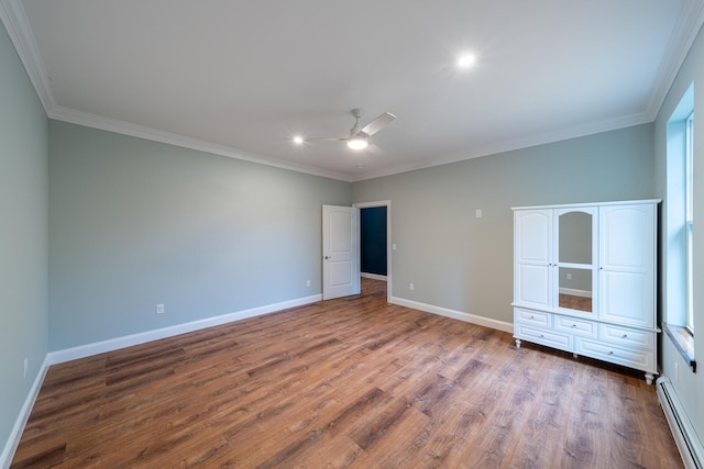 unfurnished bedroom with hardwood / wood-style flooring, ceiling fan, crown molding, and a baseboard heating unit