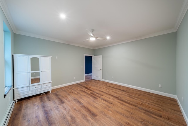 unfurnished bedroom featuring dark hardwood / wood-style flooring, a baseboard radiator, ceiling fan, and crown molding