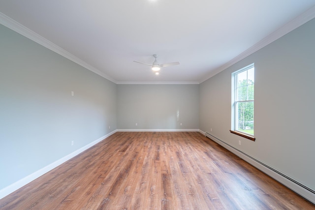 empty room featuring ceiling fan, wood-type flooring, ornamental molding, and baseboard heating