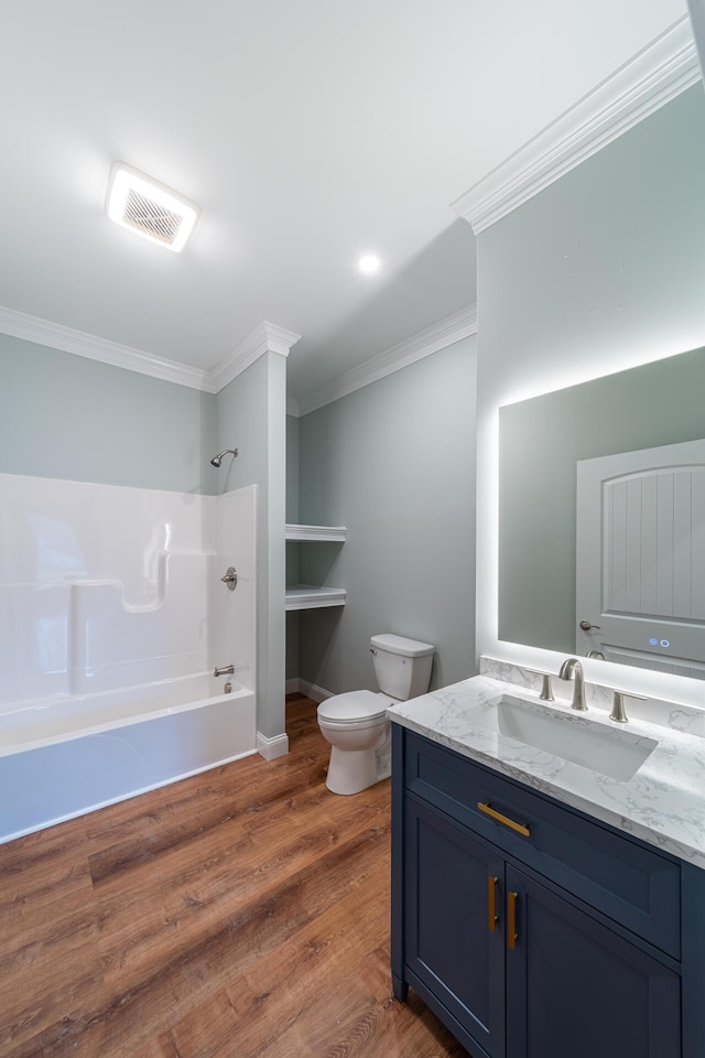 full bathroom with ornamental molding, bathtub / shower combination, vanity, hardwood / wood-style floors, and toilet