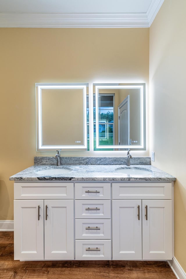 bathroom with vanity, wood-type flooring, and ornamental molding