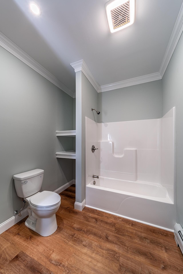 bathroom featuring hardwood / wood-style floors, toilet, shower / bath combination, and crown molding