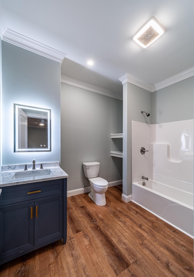 full bathroom with ornamental molding, bathtub / shower combination, vanity, hardwood / wood-style flooring, and toilet