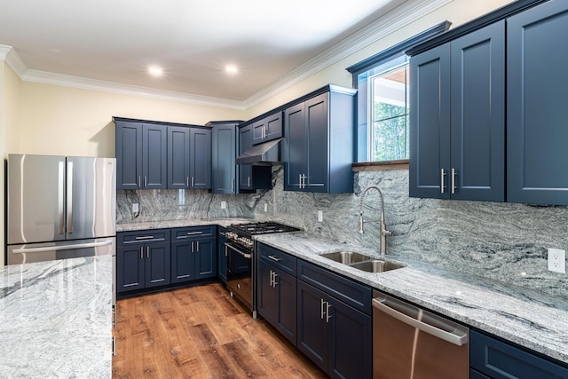 kitchen with appliances with stainless steel finishes, backsplash, light stone counters, dark wood-type flooring, and sink