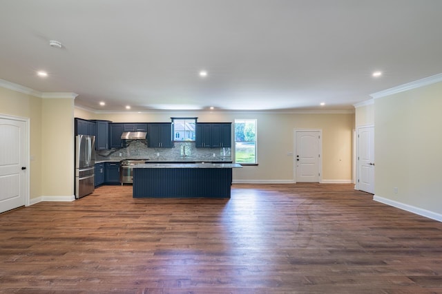 kitchen featuring dark hardwood / wood-style floors, decorative backsplash, ornamental molding, appliances with stainless steel finishes, and a kitchen island