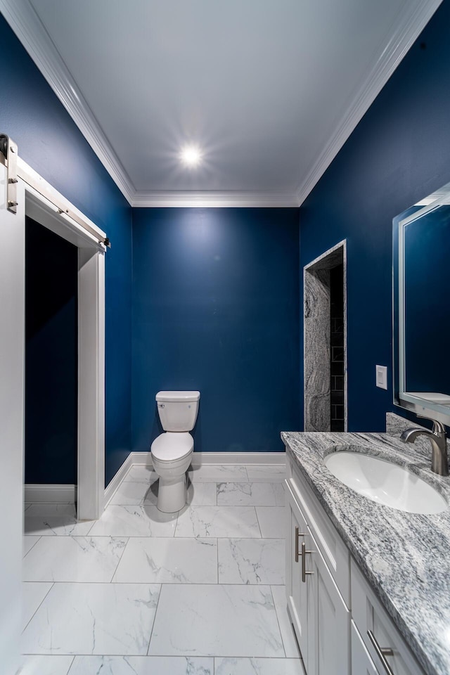 bathroom with crown molding, vanity, and toilet