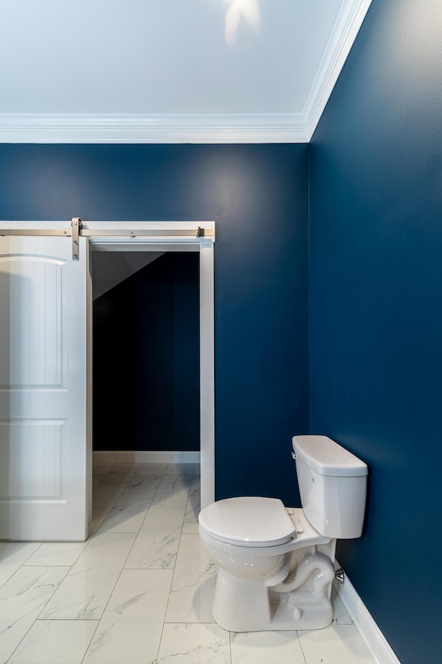 bathroom featuring crown molding and toilet