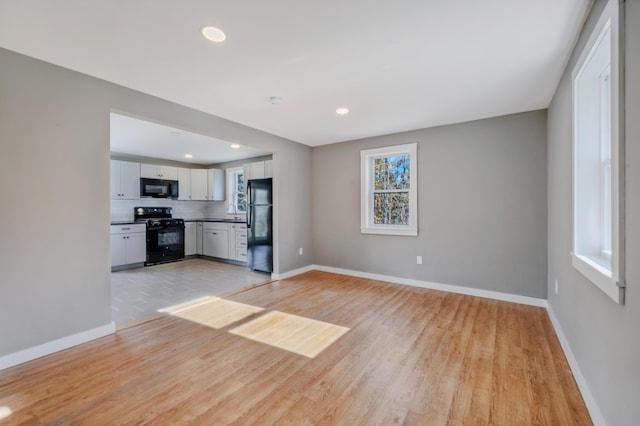 unfurnished living room featuring light wood-type flooring