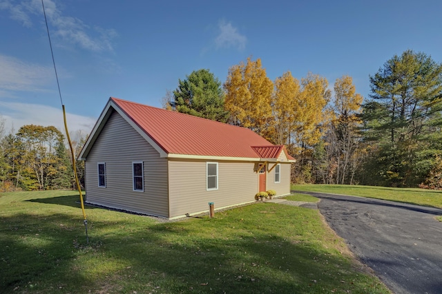 view of side of property with a yard