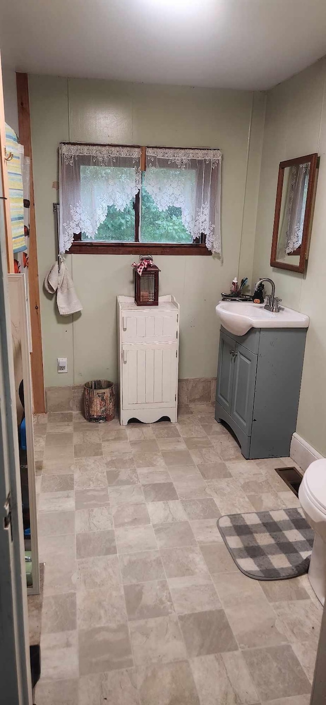 bathroom featuring vanity and toilet