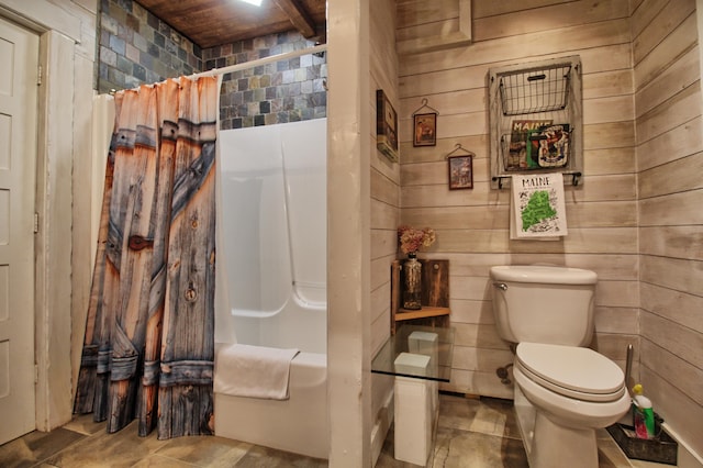 bathroom with toilet, wood walls, and shower / tub combo