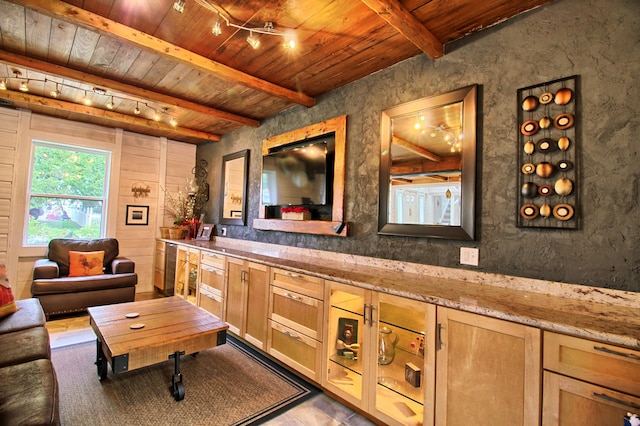 interior space featuring wooden ceiling, track lighting, and beam ceiling