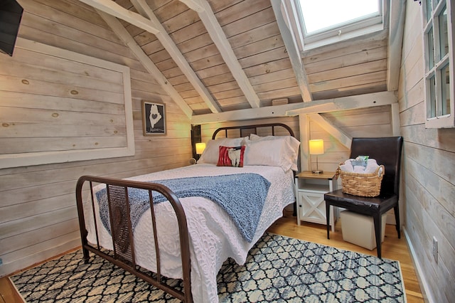 bedroom featuring light wood-type flooring, lofted ceiling with skylight, wooden walls, and wooden ceiling