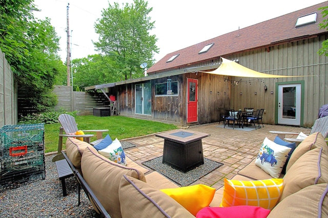 view of patio with an outdoor living space with a fire pit