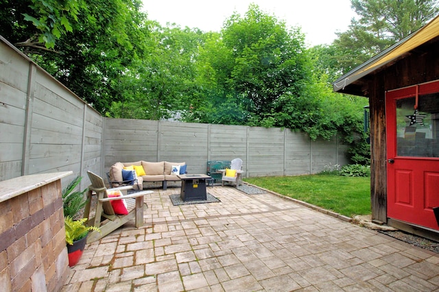 view of patio featuring an outdoor living space with a fire pit