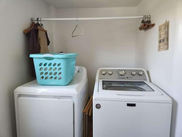 clothes washing area featuring independent washer and dryer