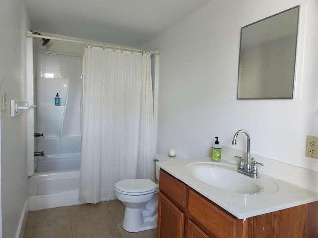 full bathroom featuring toilet, tile patterned floors, vanity, and shower / bath combo with shower curtain