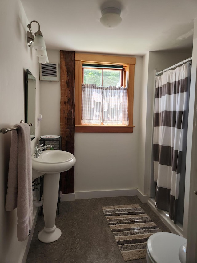 bathroom with toilet and curtained shower