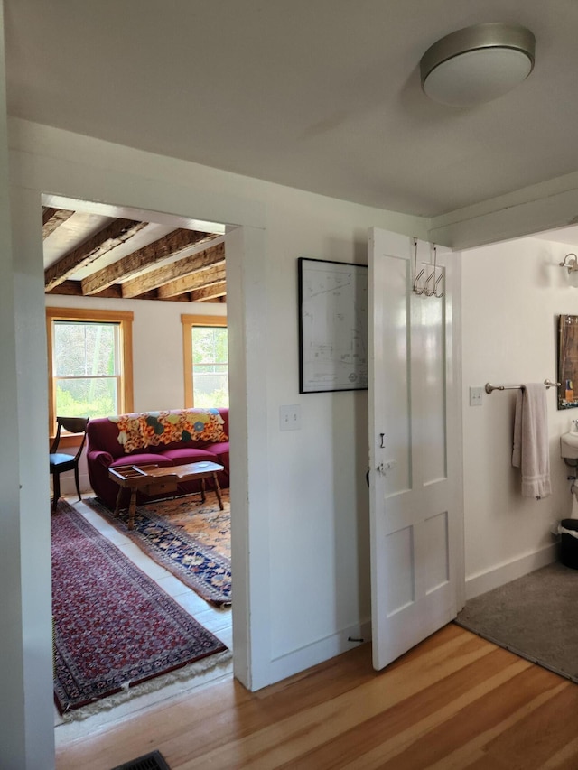 interior space with hardwood / wood-style floors and beamed ceiling