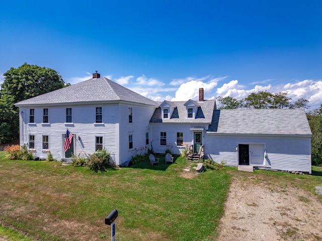 rear view of house featuring a lawn