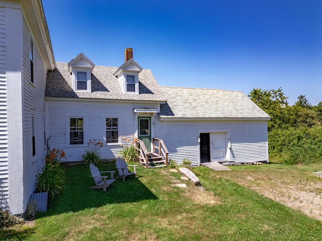 back of property featuring a yard