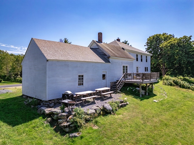 back of house with a yard and a wooden deck