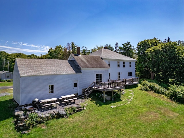 rear view of property with a patio area, a wooden deck, and a yard