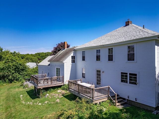 back of house with a wooden deck and a yard