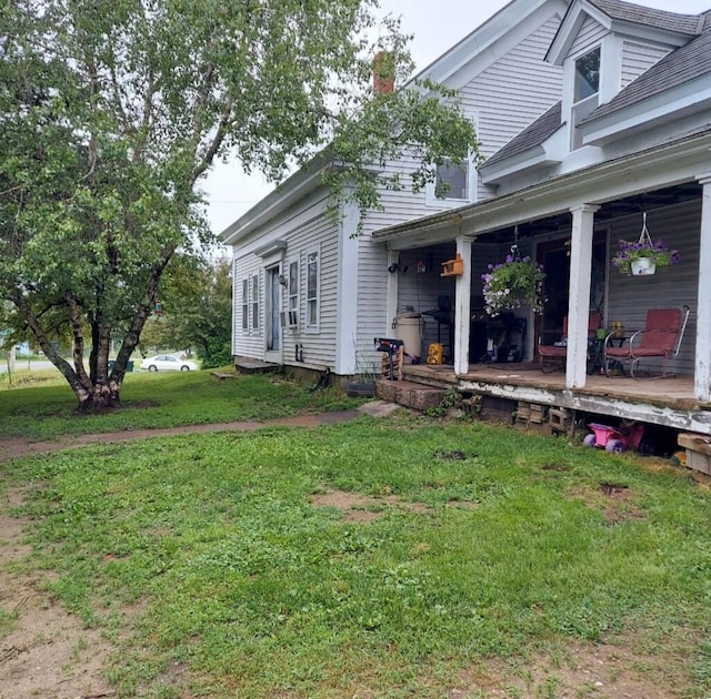 view of side of property with a lawn