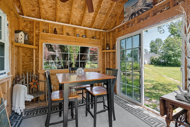 sunroom with ceiling fan and vaulted ceiling