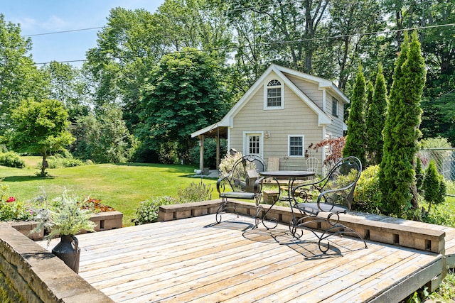 wooden deck featuring a lawn