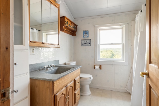 bathroom with tile floors, oversized vanity, toilet, and tile walls