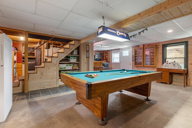 rec room with wood walls, a paneled ceiling, billiards, and concrete flooring