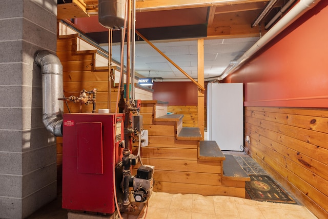 basement featuring wooden walls