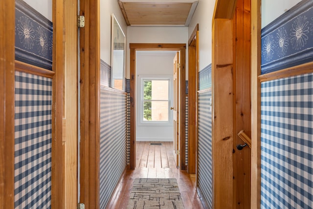 hall featuring wood ceiling and wood-type flooring