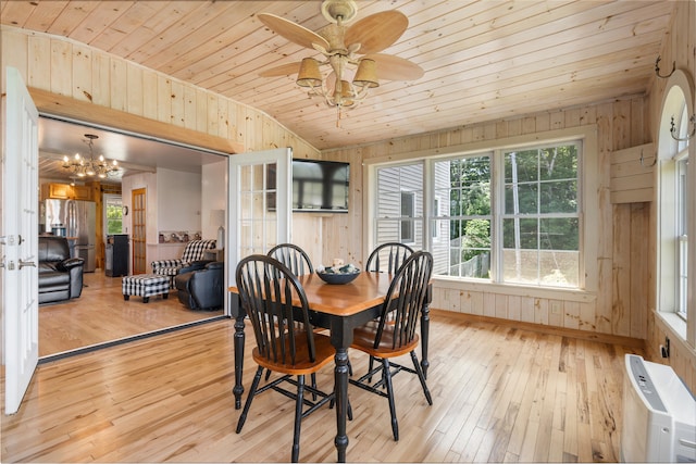 dining area with wooden walls, a healthy amount of sunlight, light hardwood / wood-style floors, and wooden ceiling